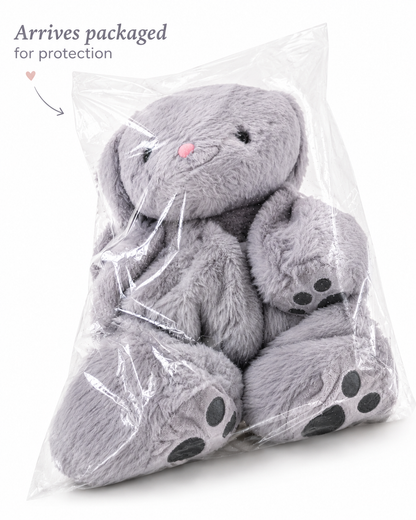 Gray plush bunny in clear packaging with text 'Arrives packaged for protection'.