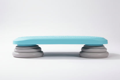 Side view of a blue mini kids’ sensory trampoline showing its sturdy grey stacked support legs, designed for stable jumping, balance training, and sensory play.