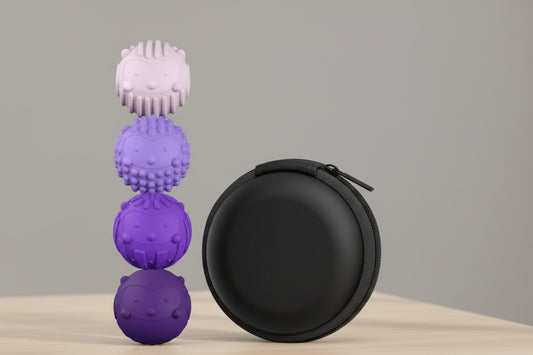 Set of purple textured fidget balls with a black carrying case on a white background