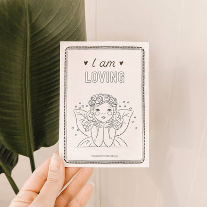 Card with 'I am LOVING' text and a line drawing of a woman held by a hand.
