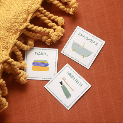 Three educational cards about bedtime routine on a textured surface with a yellow blanket.