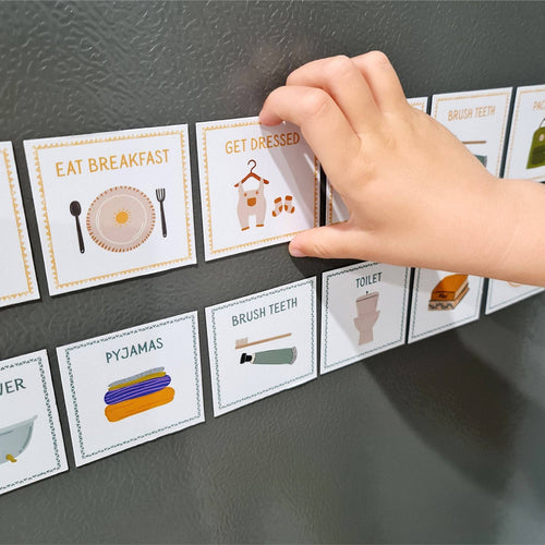 Hand interacting with educational cards on a dark surface