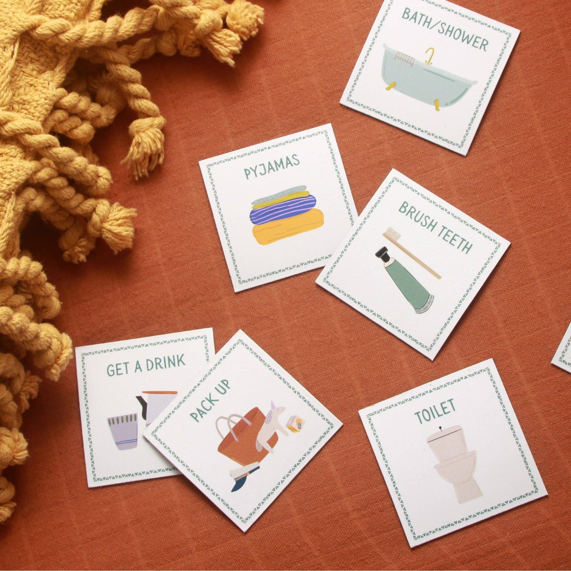 Educational cards on a wooden surface with illustrations and text.
