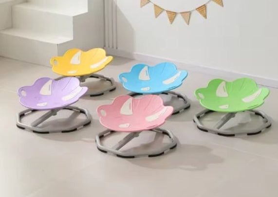 Set of colorful sensory chairs with dinosaur design on a light floor.